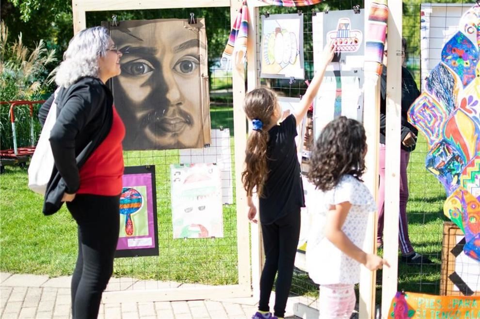  People looking at artwork at Hispanic Heritage Celebration